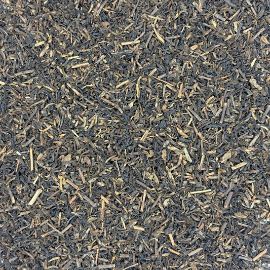 Close-up of Decaffeinated black tea leaves on a white background