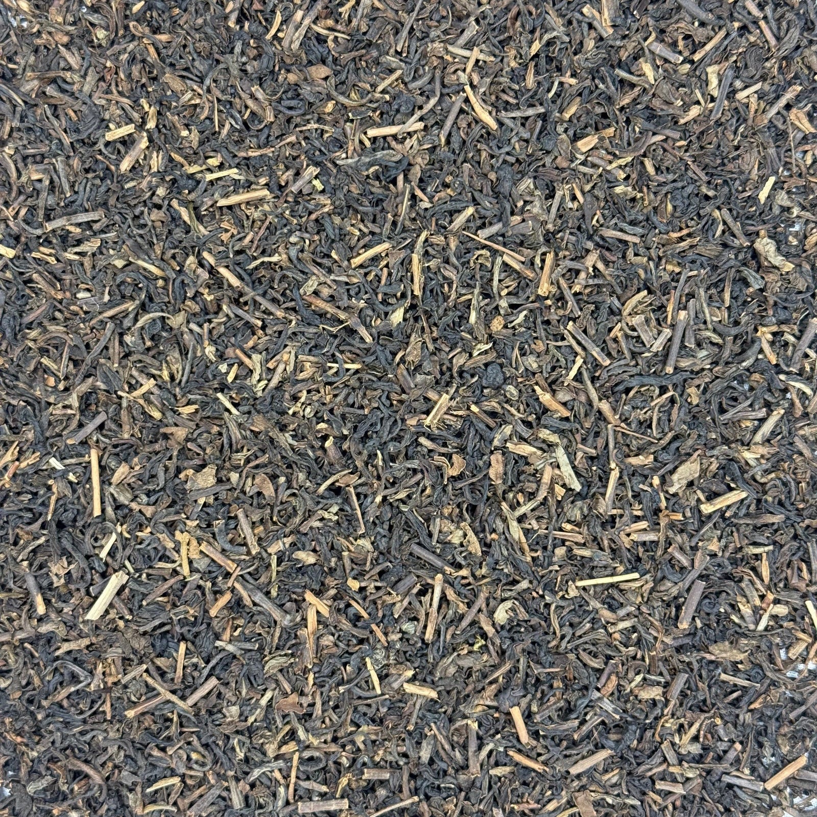 Close-up of Decaffeinated black tea leaves on a white background