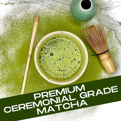 Ceremonial grade matcha with a bowl, whisk, and spoon on a green surface.